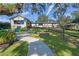 Lakefront home with fire pit and walkway at 17531 County Road 455, Montverde, FL 34756