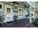 Spacious front porch with wooden swing and welcoming decor at 17531 County Road 455, Montverde, FL 34756