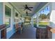 Inviting front porch with ceiling fans, bench swing, and rustic decor at 17531 County Road 455, Montverde, FL 34756