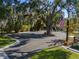 Front yard with a huge oak tree, green lawn, and American flag in the foreground at 17531 County Road 455, Montverde, FL 34756