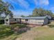 Ranch style home with metal roof and a large deck at 17531 County Road 455, Montverde, FL 34756