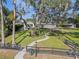 House with a large yard, walkway, and mature oak tree at 17531 County Road 455, Montverde, FL 34756