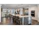 Modern kitchen with stainless steel appliances, white cabinets and an island with seating at 17531 County Road 455, Montverde, FL 34756