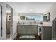 Modern galley kitchen with white cabinets and quartz countertops at 17531 County Road 455, Montverde, FL 34756