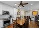 Eat in kitchen with white cabinets, stainless steel appliances, and wood floors at 17531 County Road 455, Montverde, FL 34756