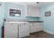 Laundry room with washer, dryer and white cabinets at 17531 County Road 455, Montverde, FL 34756