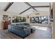 Open concept living room with hardwood floors, exposed beams, and large windows at 17531 County Road 455, Montverde, FL 34756