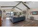 Spacious living area with vaulted ceilings, exposed beams, and a cozy fireplace at 17531 County Road 455, Montverde, FL 34756