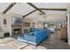 Open concept living room with a fireplace, exposed beams, and hardwood floors at 17531 County Road 455, Montverde, FL 34756