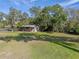 Small barn with a metal roof and adjacent grassy field at 17531 County Road 455, Montverde, FL 34756