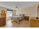 Comfortable bedroom with wood floors and plenty of natural light at 202 Estrada Pl, The Villages, FL 32159