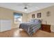 Bright bedroom featuring wood flooring and ample closet space at 202 Estrada Pl, The Villages, FL 32159