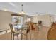 Bright dining area with glass table and chairs near living room at 202 Estrada Pl, The Villages, FL 32159