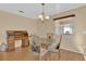 Formal dining room with wood desk, glass table and four chairs at 202 Estrada Pl, The Villages, FL 32159