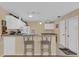 Bright kitchen features white cabinets, breakfast bar, and built-in bench seating at 202 Estrada Pl, The Villages, FL 32159