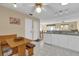 Kitchen with wood breakfast nook, white cabinets, and view into dining area at 202 Estrada Pl, The Villages, FL 32159