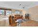 Relaxing living room with leather furniture and sliding doors to patio at 202 Estrada Pl, The Villages, FL 32159