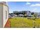 A serene neighborhood street view, showcasing well-maintained lawns and charming homes under a clear, blue sky at 202 Estrada Pl, The Villages, FL 32159