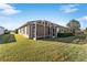 House with screened patio and lush green lawn at 2131 Baldwin Run, The Villages, FL 32162