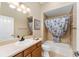 Bathroom with tub shower, vanity, and linen storage at 2131 Baldwin Run, The Villages, FL 32162