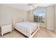 Bright bedroom with a queen bed and large window at 2131 Baldwin Run, The Villages, FL 32162