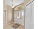 Well-lit entryway with tile floors, a coat closet, and interior door at 2131 Baldwin Run, The Villages, FL 32162