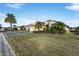 Landscaped yard with palm trees and a large driveway at 2131 Baldwin Run, The Villages, FL 32162
