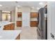 Kitchen boasts stainless steel appliances and wood cabinetry at 2131 Baldwin Run, The Villages, FL 32162