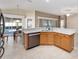 Spacious kitchen with island, granite countertops, and stainless steel appliances at 2131 Baldwin Run, The Villages, FL 32162