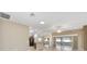 Open living room with tile floors, sliding doors to lanai, and high ceiling at 2131 Baldwin Run, The Villages, FL 32162