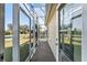 Screened-in porch with access to the backyard at 2131 Baldwin Run, The Villages, FL 32162