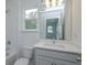 Bright bathroom with white vanity, toilet, and shower at 2137 Sunshine Peak Dr, Minneola, FL 34715