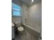A full bathroom with a shower-tub combo, a toilet, a vanity, and marble-patterned flooring at 2137 Sunshine Peak Dr, Minneola, FL 34715