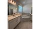 Primary bathroom features double vanities and a large soaking tub at 2137 Sunshine Peak Dr, Minneola, FL 34715