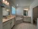 Bathroom featuring double sinks, a soaking tub, and modern lighting at 2137 Sunshine Peak Dr, Minneola, FL 34715