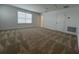 This large bedroom features neutral carpet, a window with blinds, and an access panel in the ceiling at 2137 Sunshine Peak Dr, Minneola, FL 34715