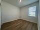Cozy bedroom with wood-look floors and a bright window at 2137 Sunshine Peak Dr, Minneola, FL 34715