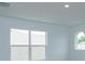 Well-lit bedroom with large window and arched window at 2137 Sunshine Peak Dr, Minneola, FL 34715