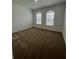 Bright bedroom with neutral carpet, two windows, and ample natural light at 2137 Sunshine Peak Dr, Minneola, FL 34715