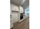 Well-equipped kitchen features stainless steel appliances and sleek white cabinetry at 2137 Sunshine Peak Dr, Minneola, FL 34715