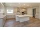 Modern kitchen with island, stainless steel appliances, and light-colored cabinetry at 2137 Sunshine Peak Dr, Minneola, FL 34715