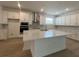Spacious kitchen with white cabinets, stainless steel appliances, and a large island at 2137 Sunshine Peak Dr, Minneola, FL 34715
