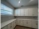 Bright kitchen with white cabinets, stone countertops, and ample counter space at 2137 Sunshine Peak Dr, Minneola, FL 34715