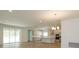 Open kitchen with island, stainless steel appliances, and sliding glass doors at 2137 Sunshine Peak Dr, Minneola, FL 34715