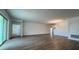 Open-concept living room with plank flooring and plenty of natural light at 2137 Sunshine Peak Dr, Minneola, FL 34715