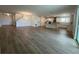 Spacious open-concept living room with modern flooring and a view of the kitchen at 2137 Sunshine Peak Dr, Minneola, FL 34715