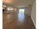 Bright open-concept living room with hardwood floors and a view of the modern kitchen at 2137 Sunshine Peak Dr, Minneola, FL 34715