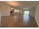 Open-concept living room with hardwood floors, a kitchen, and sliding doors to the outside at 2137 Sunshine Peak Dr, Minneola, FL 34715