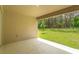 Covered patio overlooking grassy backyard and trees at 2137 Sunshine Peak Dr, Minneola, FL 34715