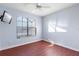 Spacious bedroom with large window and wood flooring at 233 Monterey St, Kissimmee, FL 34759